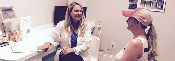 Chiropractor St Clair MI Elizabeth Brieden talking to patient Chiropractor St Clair MI Elizabeth Brieden talking to patient
